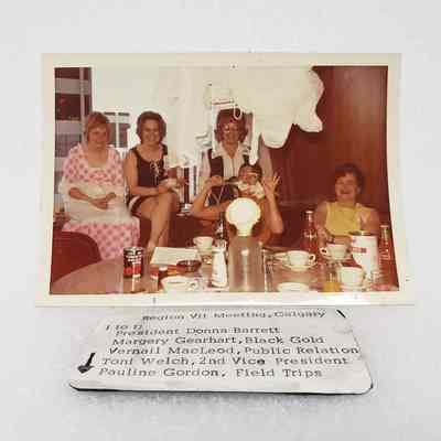 [Photo] Five Ladies Seated Together Behind Round Table, Region VII Meeting Calgary, Association of Desk and Derrick Clubs, Landscape, White Border, c.1972