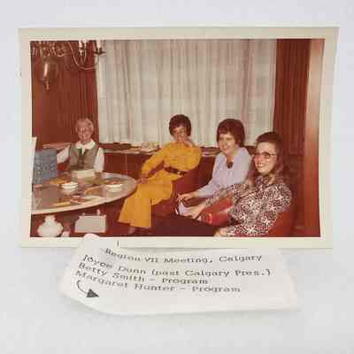 [Photo] Four Ladies Seated on a Couch and Armchairs, Region VII Meeting Calgary, Association of Desk and Derrick Clubs, Landscape, White Border, c.1972