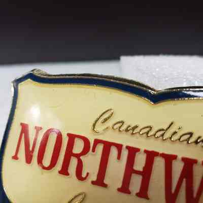 [Belt Buckle] Canadian Northwest Carrier Inc., Gold Enamel - Front, Left: Close-up view of the front, left.