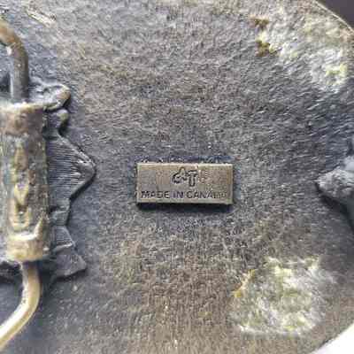 [Belt Buckle] Carey Welding, Antique-Bronze - Maker's Mark: Close-up view of the maker's mark on the back.