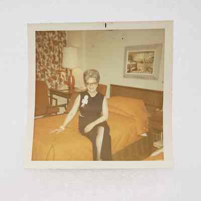 [Photo] Elizabeth Pickard Sitting on Orange Bed, Association of Desk and Derrick Clubs, Square, White Border, c.1972