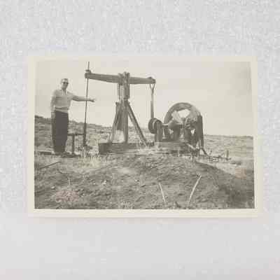 [Photo] Man Pointing at Wooden Pumpjack, BW, Small, c 1950s