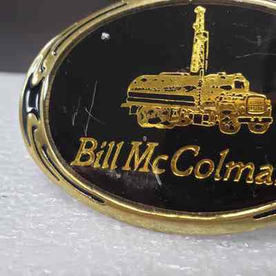 [Belt Buckle] Bill McColman, Black Gold Bronze - Front , Left: Close-up angled view of the left-side of the front.