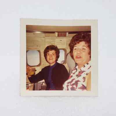 [Photo] Two Ladies Seated on Airplane, Association of Desk and Derrick Clubs, Small, Square, White Border, c.1972