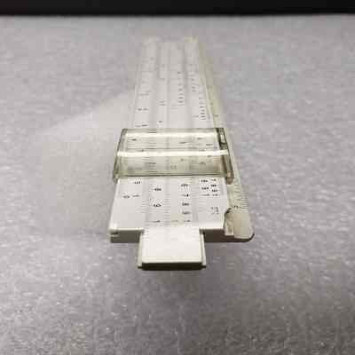 [Slide Rule] Union Carbide Chemicals and Plastics, White Plastic, Brown Leather - End Slide Rule, Angled: Angled end view of slide rule