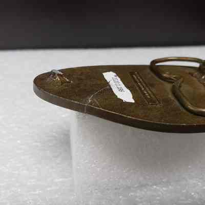 [Belt Buckle] Beaver Drilling, Antique-Bronze [Broken] - Angled, Breakage: Close-up angled view of breakage, back.