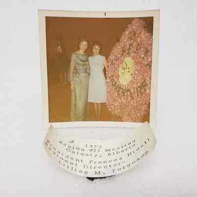 [Photo] Frances Hidell and Lillias Ferguson Beside Flower Wreath, w/ Label, Square, White Border, c.1972