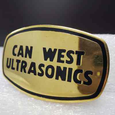[Belt Buckle] Can West Ultrasonic, Gold Black - Front, Angled: Angled view of the front.
