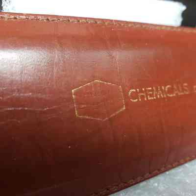 [Slide Rule] Union Carbide Chemicals and Plastics, White Plastic, Brown Leather - Close-Up Case: Close-up view of case showing faded "UNION  CARBIDE" logo text.