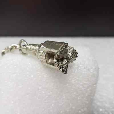 [Keychain] Macbernal Recyling Systems Ltd., Drill Head, Silver - Angled Top, Drill: Angled view of drill head attachment, top.
