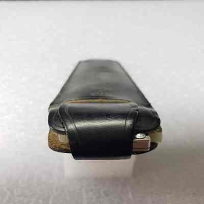 [Slide Ruler] Pritchard Canadian Ltd., A. Kowalchuk, Black Leather - Opening Case Angled: Angled view of the case's opening with closed flap.