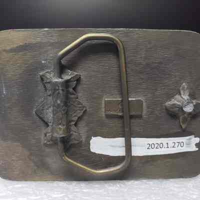 [Belt Buckle] Carnohan Enterprises Inc., Oilfield Construction, Antique-Bronze Orange Black [Broken] - Back: View of the back.