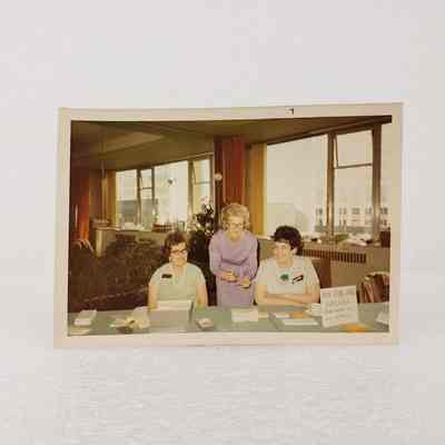 [Photo] Three Women Behind Table, Babysitting Service, Association of Desk and Derrick Clubs, Landscape, White Border, c.1972