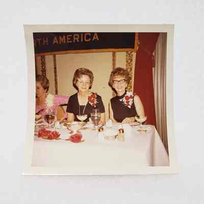 [Photo] Two Ladies Seated at Dining Table, Association of Desk and Derrick Clubs, Square, White Border, c.1972