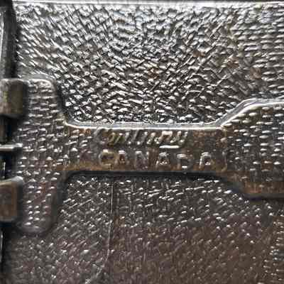 [Belt Buckle] CEDA, Maple Leaf, Antique-Bronze - Maker's Mark: Close-up view of the maker's mark on the back.