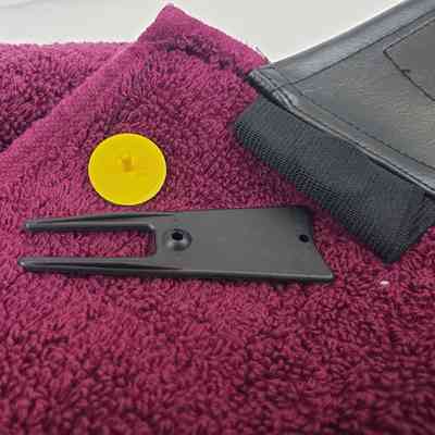 Close-Up of Ball Marker and Green Fork Tool