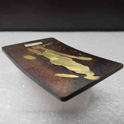 [Belt Buckle] Challenger Drilling, Antique-Copper [Damaged] - Back, Angled: Angled view of the back, showing intentionally removed hook and hinge.