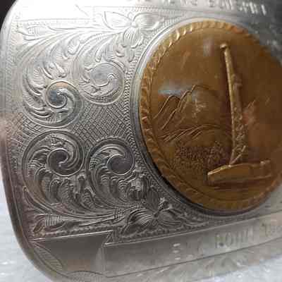 [Belt Buckle] Oilmens Bonspiel Elk Point, 1985, Silver Bronze - Front, Side Detail: Close-up of side detail on front.
