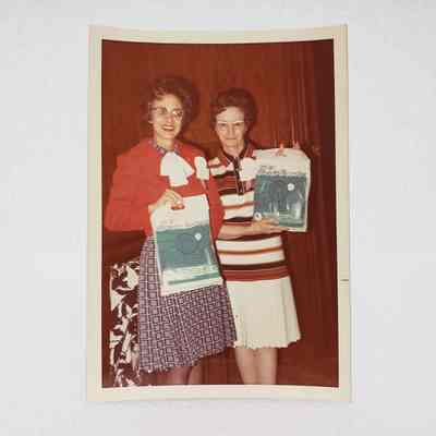 [Photo] Frances Hidell and Lillias Ferguson Holding Bags, White Border, c.1972