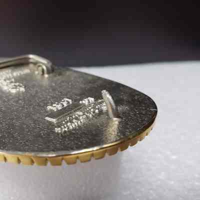[Belt Buckle] TOTCO, 1981, Gold Silver - Hook, Angled: Angled close-up view of hook