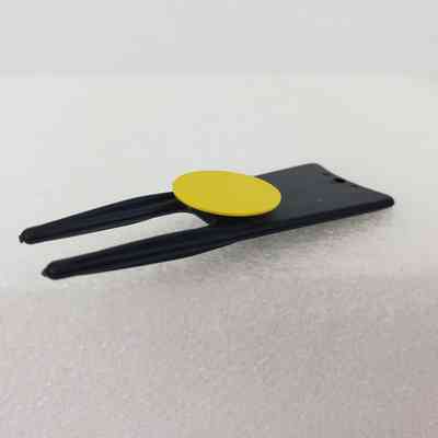 Close-Up of Ball Marker and Green Fork Tool