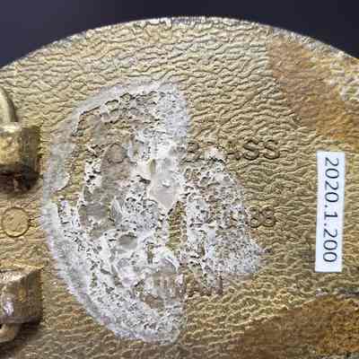 [Belt Buckle] Bill McColman, Black Gold Bronze - Maker's Mark: Close-up view of the maker's mark on the back.