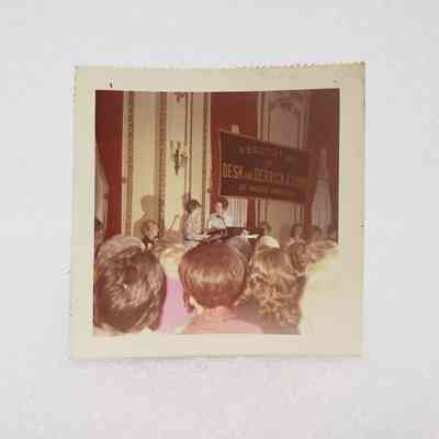 [Photo] Two Ladies Standing at Podium with Backs of Heads, Association of Desk and Derrick Clubs, Small, Square, White Border, c.1972