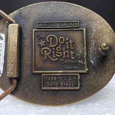 [Belt Buckle] Ashland Petroleum, Safety Award, Bronze - Maker's Mark: Close-up view of maker's mark on back.