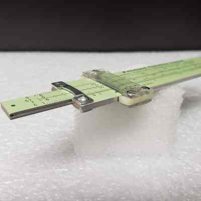 [Slide Rule] Pritchard Canadian Ltd., A. Kowalchuk, Brown Leather - Side Slide Rule, Angled: Angled side view of slide rule, top end