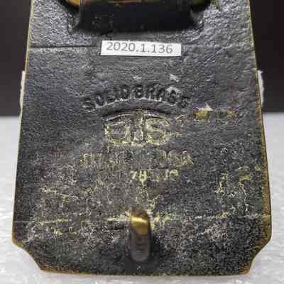 [Belt Buckle] Alberta Perforators Inc., Bronze - Maker's Mark: Close-up view of maker's mark on back.