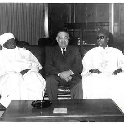 Robert Bennett sitting with two men