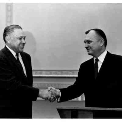 Robert Bennett shaking hands with unknown man