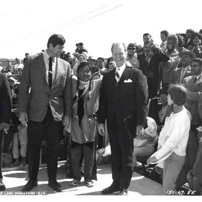 Three men in front of crowd