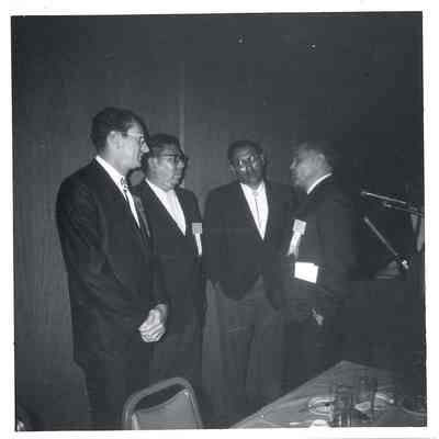 Robert Bennett talking to three men