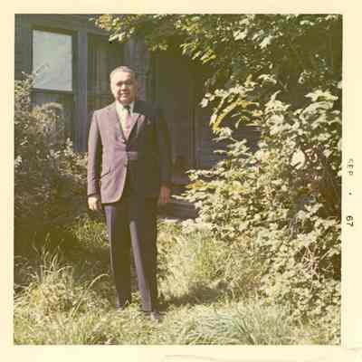 Robert Bennett in front of a house