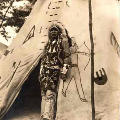 Chief Decorah in front of tipi