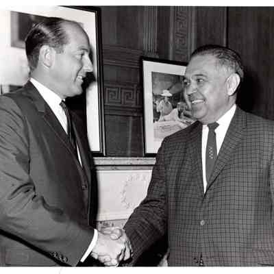Robert Bennett shaking hands with David Black
