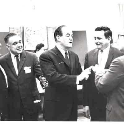 Five men greeting each other