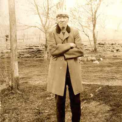 Older man wearing jacket and headdress