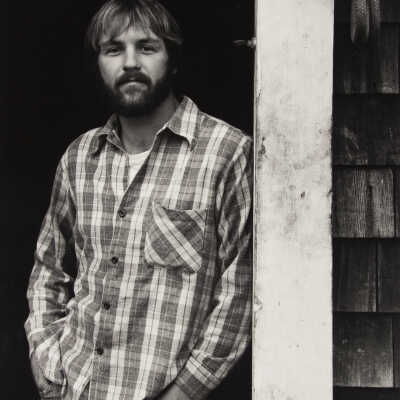 Untitled (leaning man in plaid shirt)