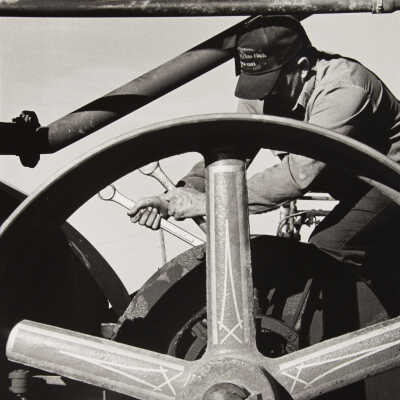 Untitled (man fixing wheel - western MN steamthreshers reunion?)
