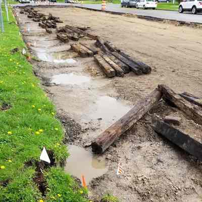 View of North Washington Avenue in Lansing facing south in front of Elderly Instruments. This spike was pried from one of these wood interurban railway ties uncovered from beneath the road pavement and prick pavers.