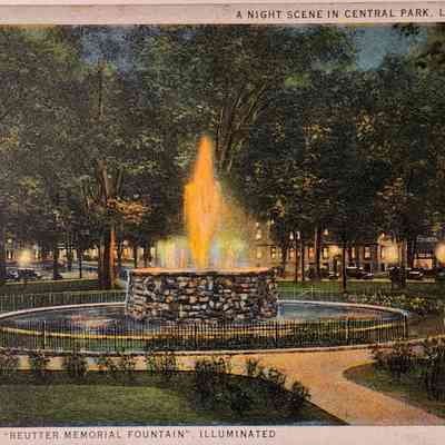 A Night Scene in Central Park, Lansing, Mich., Showing the "Reutter Memorial Fountain" Illuminated, Postcard