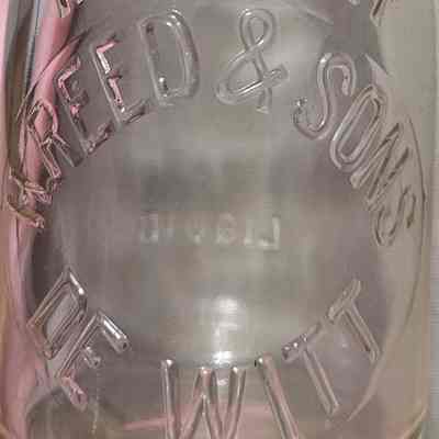 H. Reed & Sons DeWitt Embossed Half Pint Bottle
