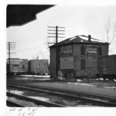 PH-1232-Rugen Store building by railroad tracks; Baxter Lab storage building in background 3-6-1947