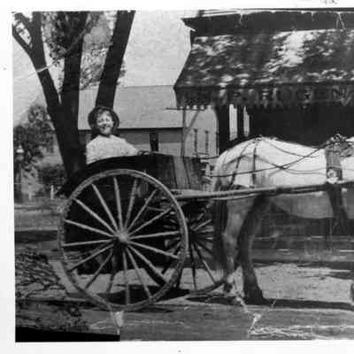 PH-0129-: Ronald Rugen in cart pulled by Bones, his horse, in front of H.P. Rugen Meat Market, on Glenview Rd