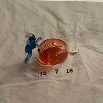 Glass figurine of elephant attached to circular glass disk