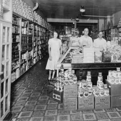 PH-0807--Early Rugen Store (1920s) - 2 male and 1 woman clerks, canned goods lining walls