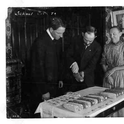 PH-0601-Rugen School superintende of school Tobin, Professor Holden and Mrs. Herman Rugen Sr. corn testing at Rugen school 1
