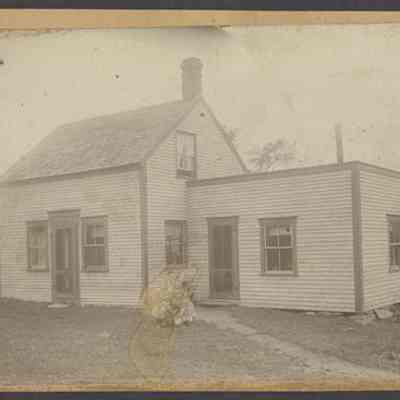 Woman and Children in Front of House